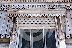 Close-up old window with carved wooden platband.