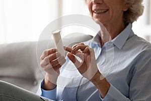 Close up of old woman read prescription on meds bottle