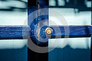 Close up of an old wood blue door. Sun shade