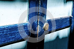 Close up of an old wood blue door. Sun shade