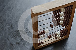 Close-up old wooden abacus on a black table