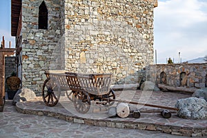 Close-up of an old wooden cart made from logs, used to transport goods