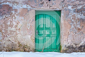 Close-up of old wooden door in winter time.