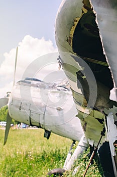 A close-up of an old wrecked passenger plane that has been decommissioned and stands for tourists. The fuselage shows traces of