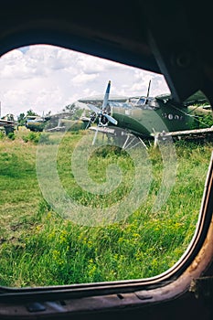 A close-up of an old wrecked passenger plane that has been decommissioned and stands for tourists. The fuselage shows traces of