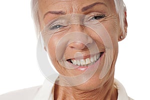 Close-up older woman with toothy smile