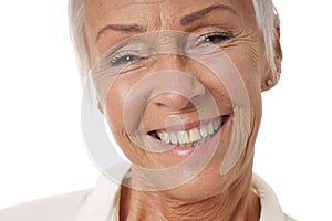 Close-up older woman with toothy smile photo