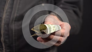 Close-up of a One Dollar in a Man's Hand in a Work Jacket. Put your Money in your Pocket