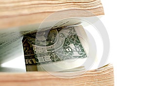 Close up of one dollar between old book pages