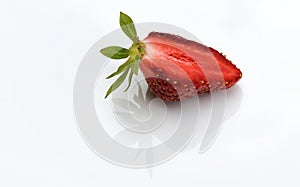 Close-up of one half of a juicy strawberry berry. Side view, macro shot on white background