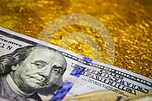 Close-up of One hundred dollar banknote on a gold close-up