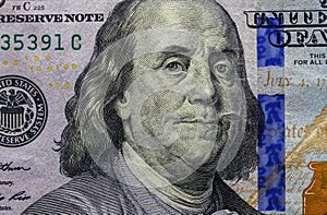 Close up of one hundred dollar banknote showing portrait of Benjamin Franklin