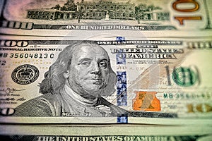 Close-up of one hundred US dollars. Many banknotes. A pile of bills of American dollars. Money background