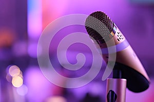 Close up one microphone in KTV with purple bokeh photo