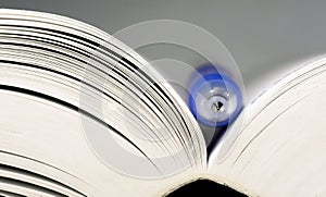 Close-up of open book and pen