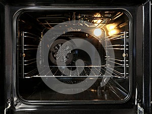 Close-up of open empty electric oven in home kitchen