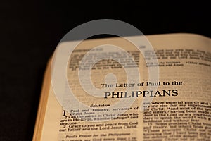 Close up of open Holy Bible Book on Philippians Epistle Letter from New Testament gospel