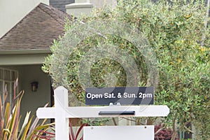 Close up of Open House sign in front of house for sale photo
