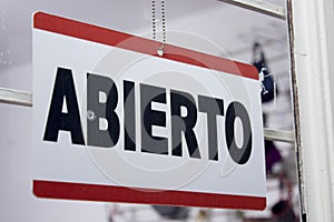 Close-up of an open sign in spanish. `Abierto`