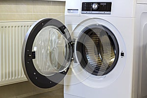 A close up of open washing machine in bathroom