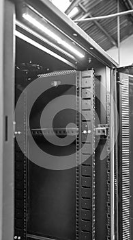 Close-up of an opened Computer Server Cabinet seen within an industrial location.