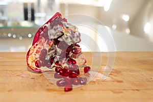 Close Up of Opened Pomegranate on a Wooden Plate