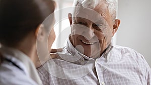Close up of optimistic mature man talk with nurse