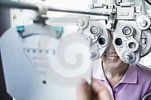 Close-up of optometrist doing an eye exam on young woman