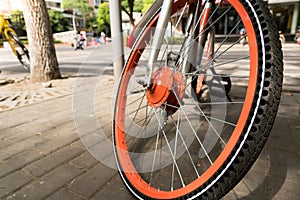 Close up the orange bicycle wheel and tire