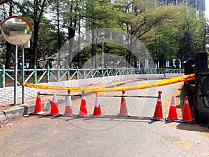 Close up of orange construction cones with yellow warning tape at road construction site in Taiwan
