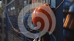 Close-up of the orange helmet of the worker on the factory.