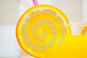 Close up of orange juice and orange slices