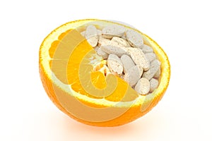 Close up of orange and pills isolated