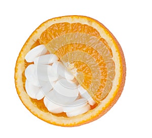 Close up of orange and pills isolated - vitamin concept