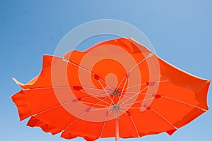 Close up orange umbrellas in beach, Italy