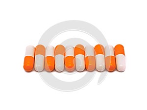 Close-up of orange-white pills row