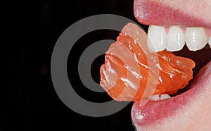 Close-up orange in the woman`s mouth