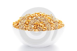 Close-up of Organic Bengal Gram Cicer arietinum or split yellow chana dal inside a ceramic white bowl