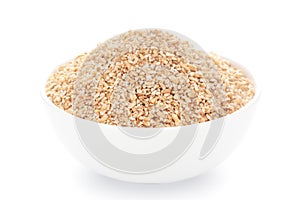 Close-Up of organic broken wheat dalia or daliya  roasted  in white ceramic bowl over white background
