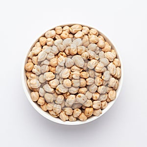 Close up of Organic chhole chana or Kabuli chana Cicer arietinum or whole white Bengal gram dal on a ceramic white bowl.