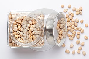 Close up of Organic chhole chana or Kabuli chana Cicer arietinum or whole white Bengal gram dal in a glass jar with Lid.