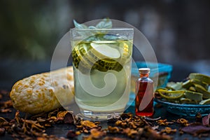 Close up of organic face pack of cucumber with aloe vera gel and rose oil on wooden surface in a glass container for Sunburns and