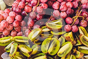 Close up of organic fresh and ripe red grapes on a luxury buffet dressed with kiwi fruit for a healthy breakfast or