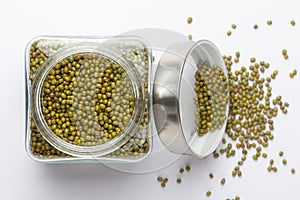 Close up of Organic green Gram Vigna radiata or whole green moong dal in a glass jar with Lid.