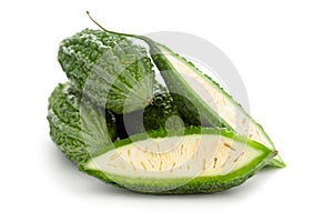 Close-Up of Organic Indian bitter gourds Momordica charantia or fresh Green Karela, cross section or vertical sliced, isolated