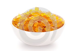 Close-up Organic yellow tutti frutti sweet soft candy  in white ceramic  bowl on white background photo