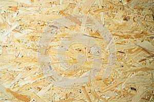 Close-up of oriented strand board. Construction background from osb panel. Industrial universal building material from wood waste