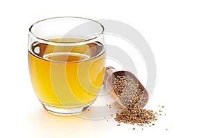 Close-Up of original  organic boiled water Tea or kada  with Ajwain  Trachyspermum ammi  in a transparent glass cup over white photo