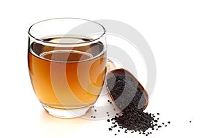 Close-Up of original  organic boiled water Tea or kada  of  kalonji Nigella sativa  in a transparent glass cup over white photo