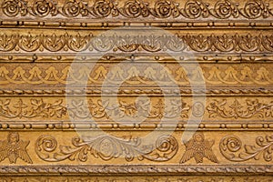 Close up ornamental wood carvings on the wall of monasteries in